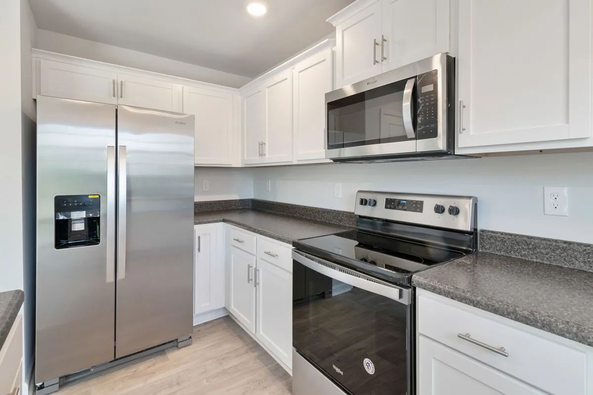 Modern kitchen with a stainless refrigerator, range and microwave